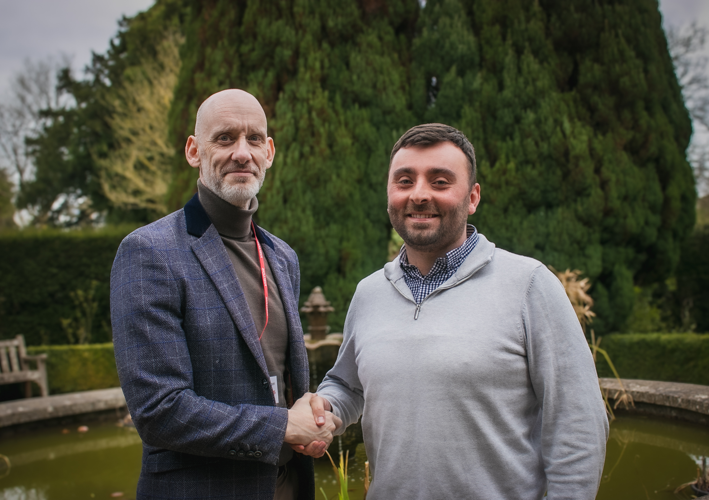 Robert Cooke and James Dunham are shown shaking hands