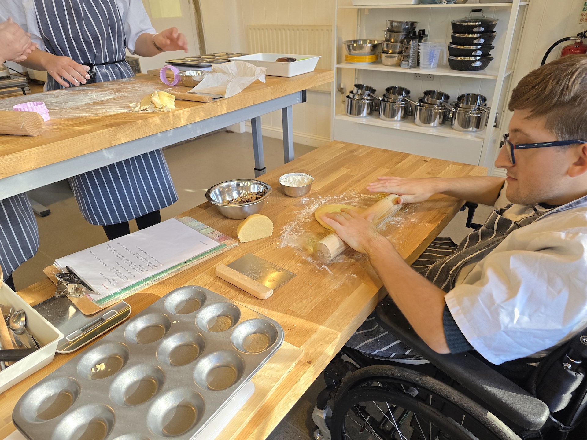 An EMA student using a rolling pin while baking mince pies in the EMA Moreton Campus Training Kitchen..